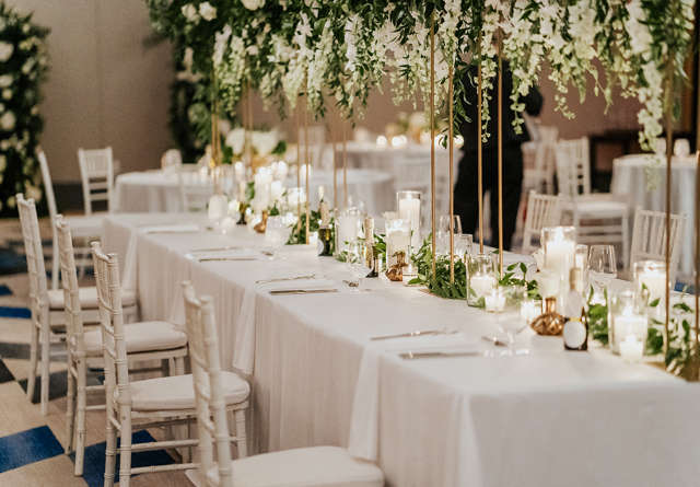 Elegant event setup with tables, white tablecloths, and floral centerpieces at Virgin Hotels Nashville.