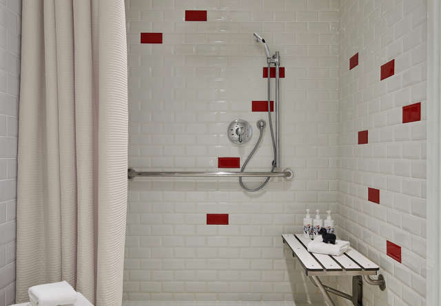 ADA compliant bathroom with modern fixtures at Virgin Hotels