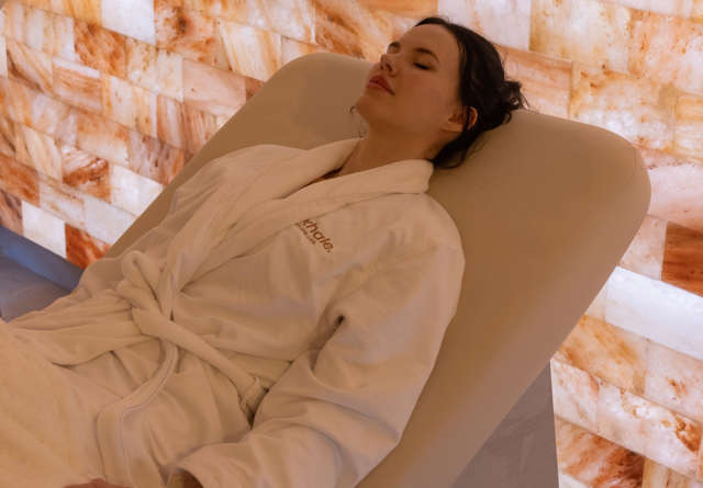 Woman lying on a lounger with spa robe in Virgin Hotels Exhale Spa