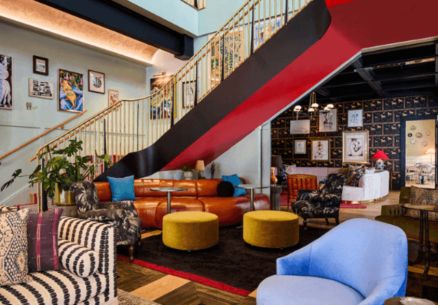 A cosy seating area featuring comfortable chairs, a stylish table, and modern decor in a relaxed setting.