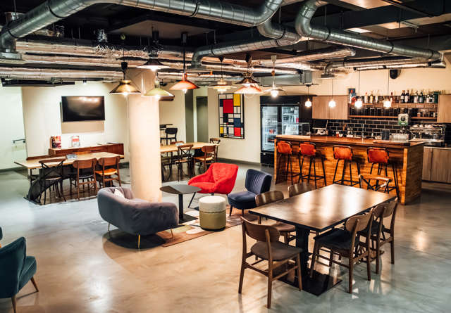 Stylish lounge area with comfortable seating and warm lighting at Virgin Hotels.